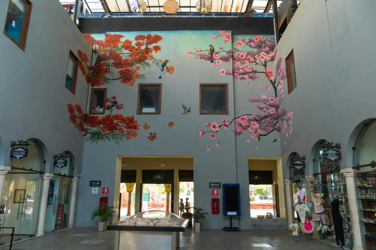 Interior mural with cherry blossoms and birds integrated into a commercial space
